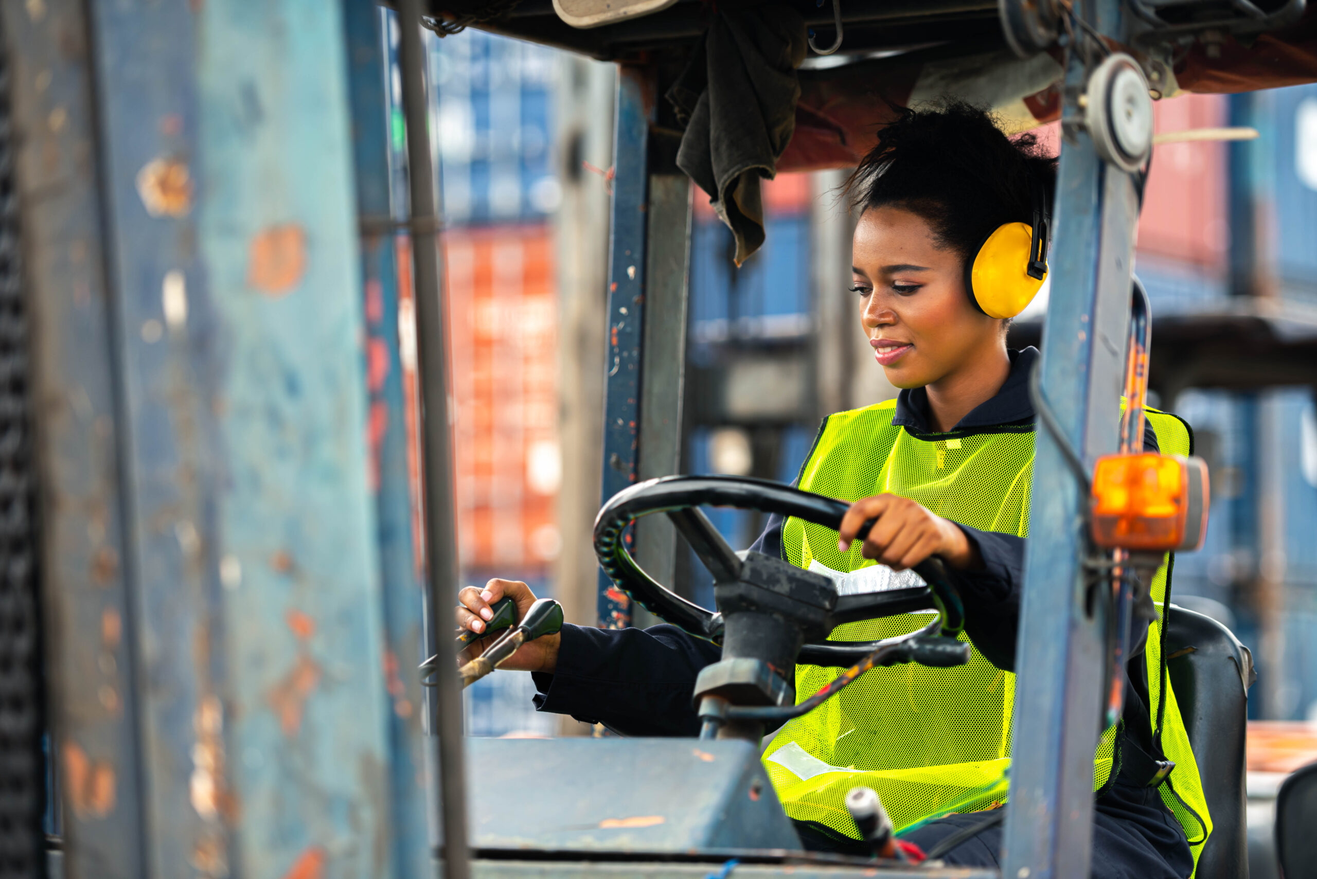 a woman on a forklift in a warehouse
