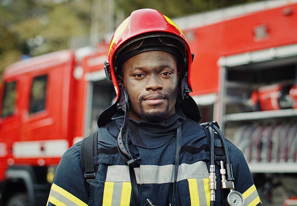 a firefighter standing in front of a fire truck