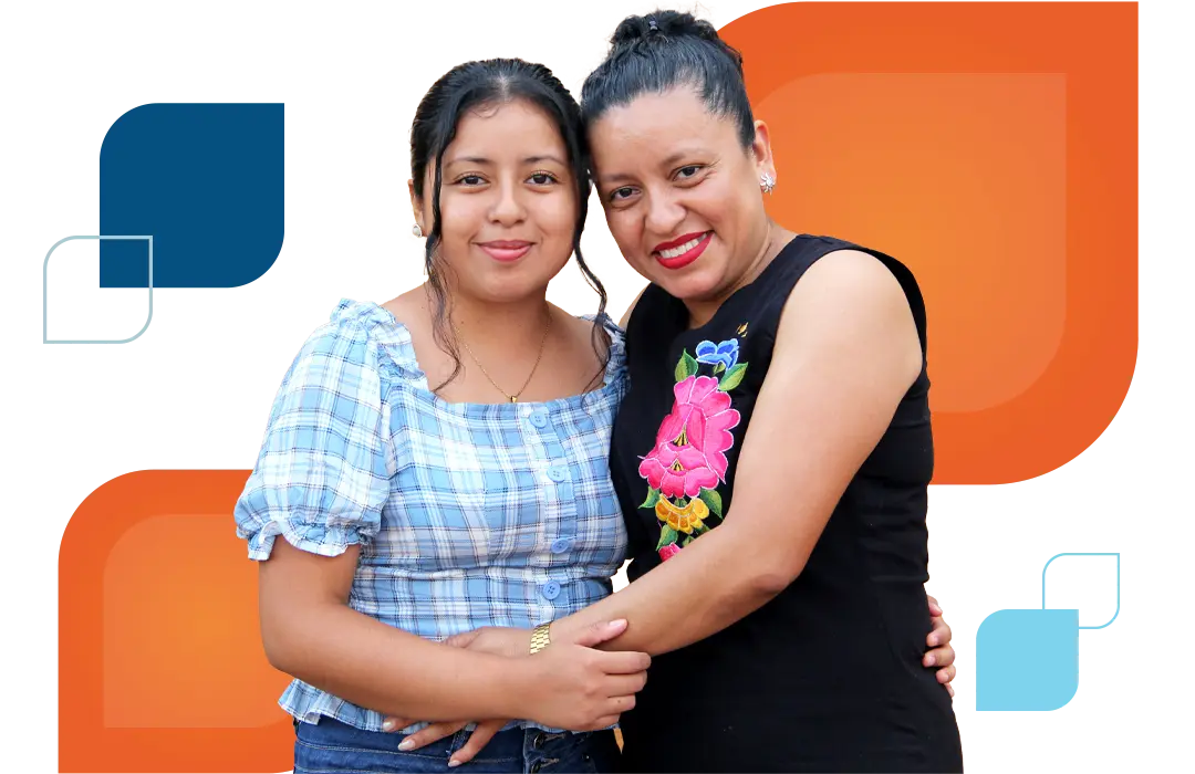 a woman and a girl hug while facing the camera