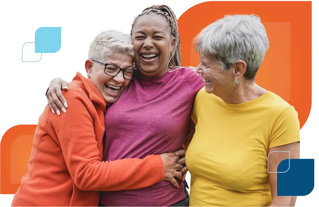 three older woman hug and smile